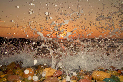 Close-up of water splashing onto pebbles with a blurred background. Shot in San Diego, California. © Randy Dible Photo