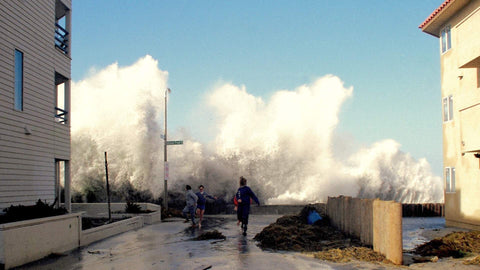 Large waves crashing against a building with people observing, Winter of 1989 Mission Beach. Shot in San Diego, California. © Randy Dible Photo