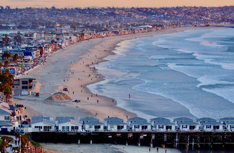Beach scene with pier and city skyline at sunset. Shot in San Diego, California. © Randy Dible Photo