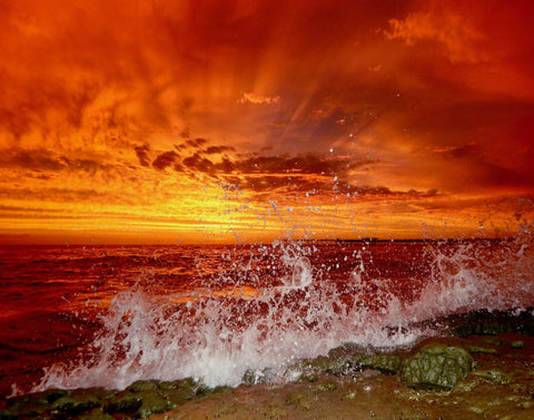 Sunset over the ocean with fiery red and orange sky and crashing waves. Shot in San Diego, California. © Randy Dible Photo