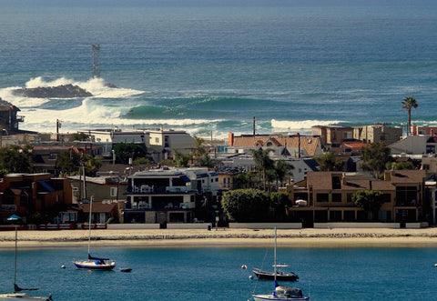 Coastal cityscape with houses, boats in the water, and ocean waves. Shot in San Diego, California. © Randy Dible Photo