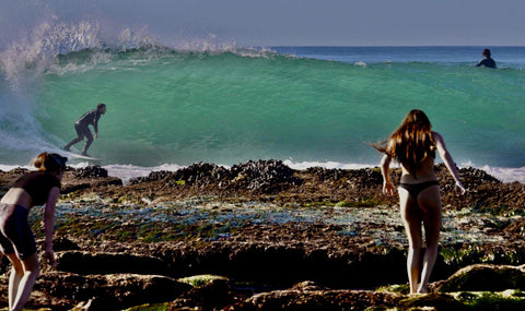 People near a rocky shoreline with waves in the background. Shot in San Diego, California. © Randy Dible Photo
